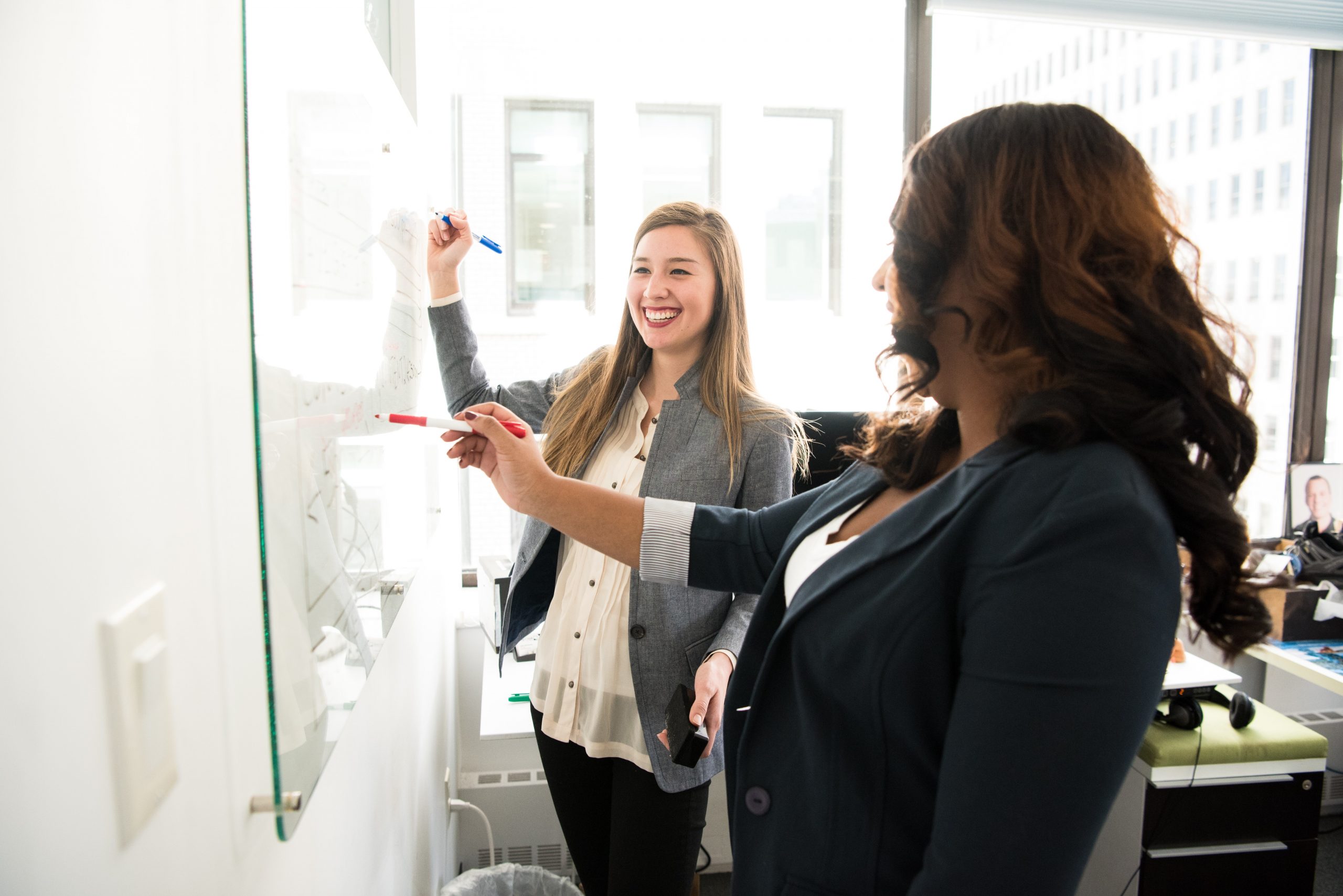 women drawing succession plan on whiteboard